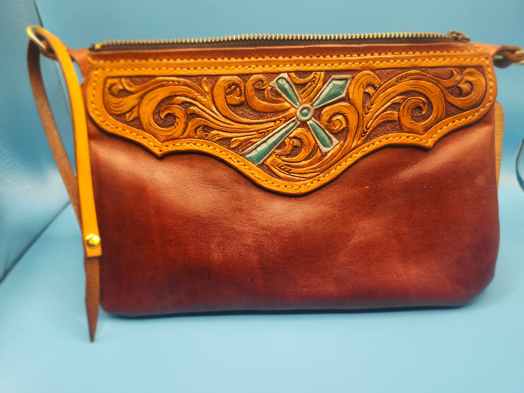 Tooled wristlet with turquoise cross.