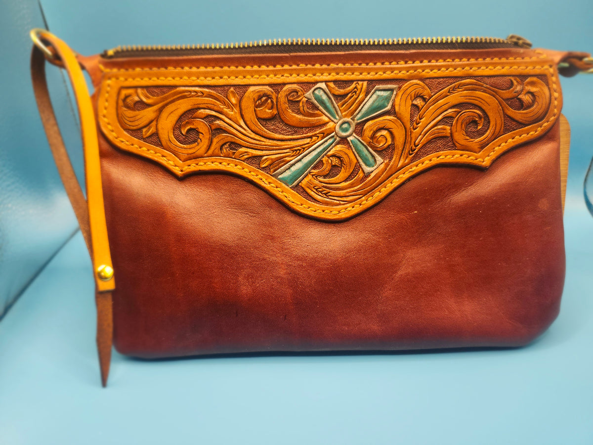 Tooled wristlet with turquoise cross.