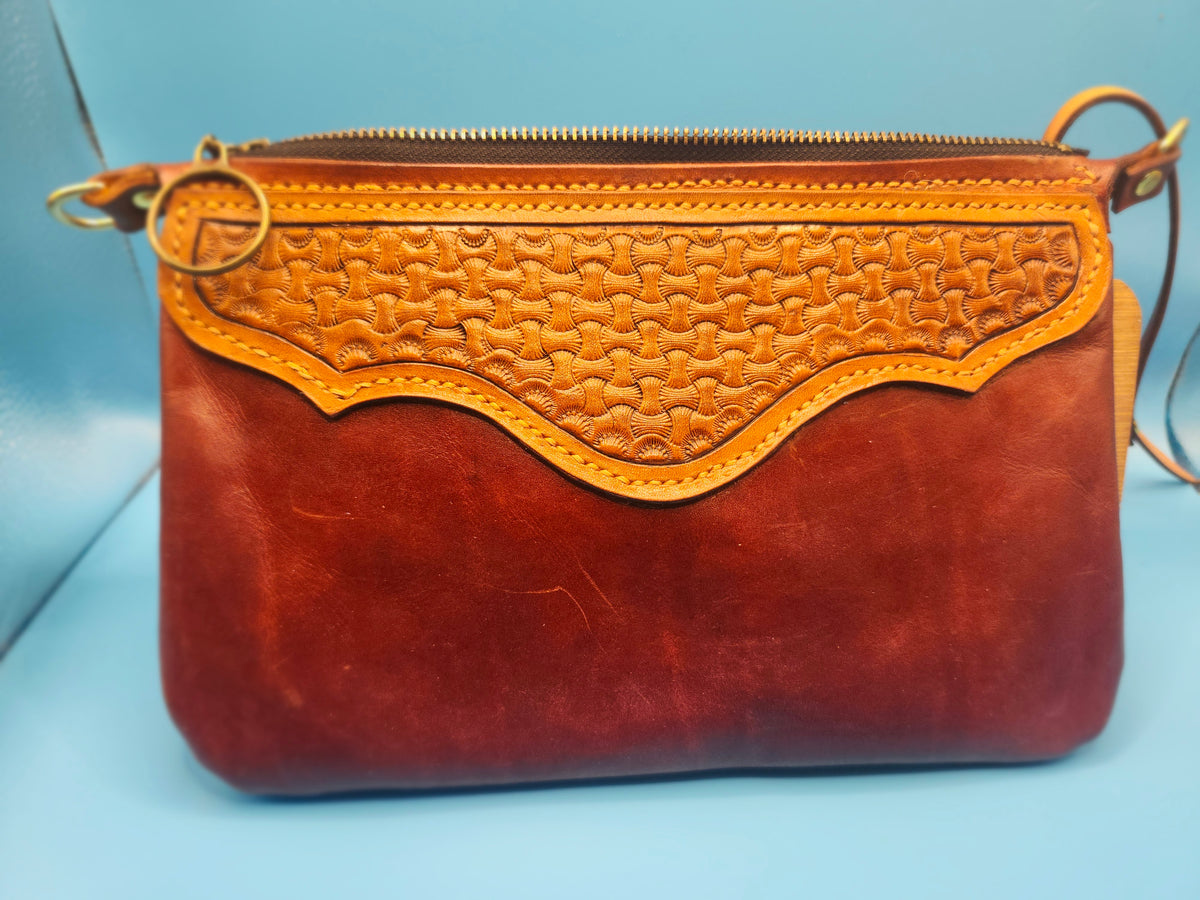 Tooled wristlet with turquoise cross.